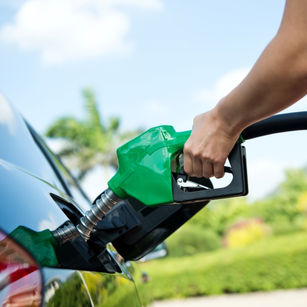 image hand pumping gas into car