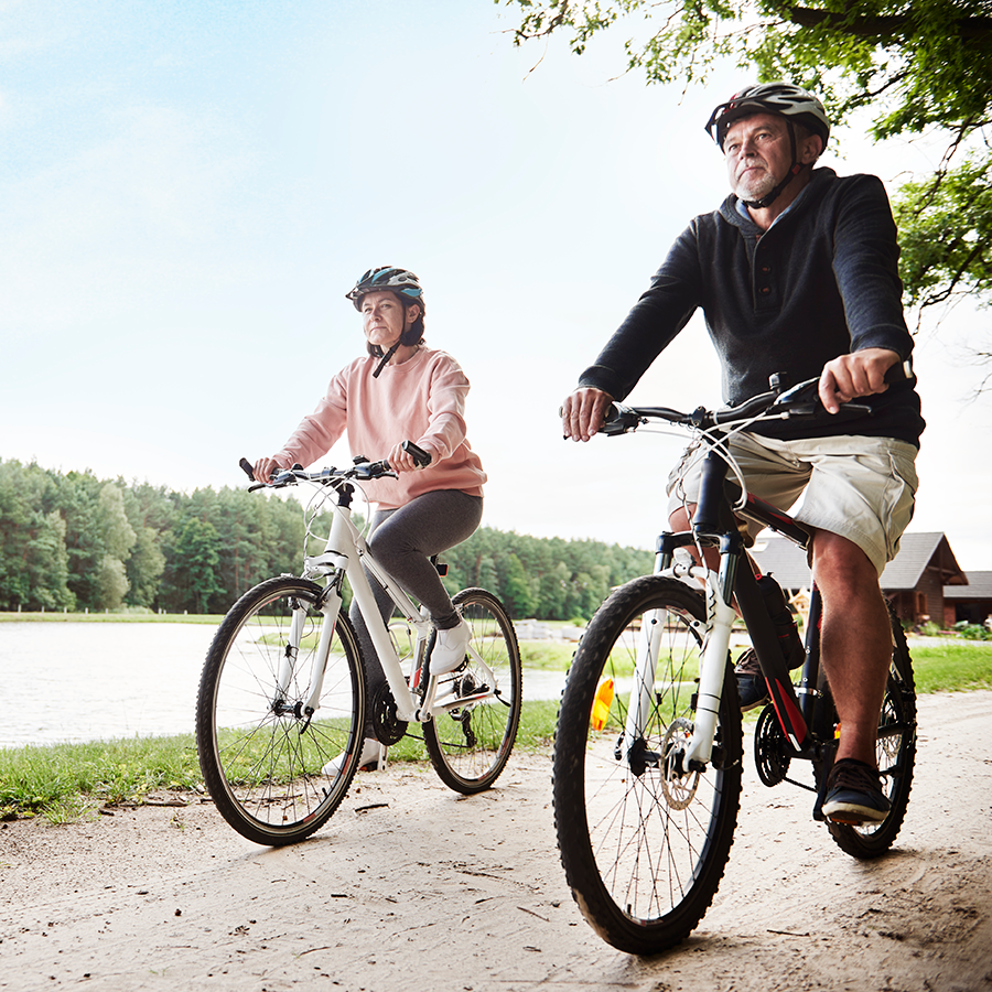 couple riding bike on trail