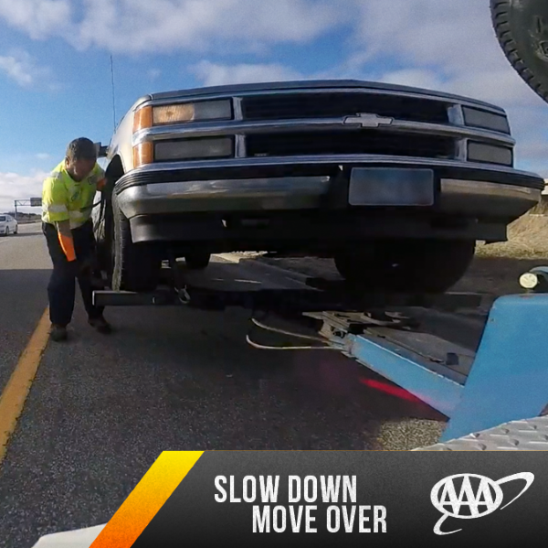 roadside technician tow operator working on the side of the road