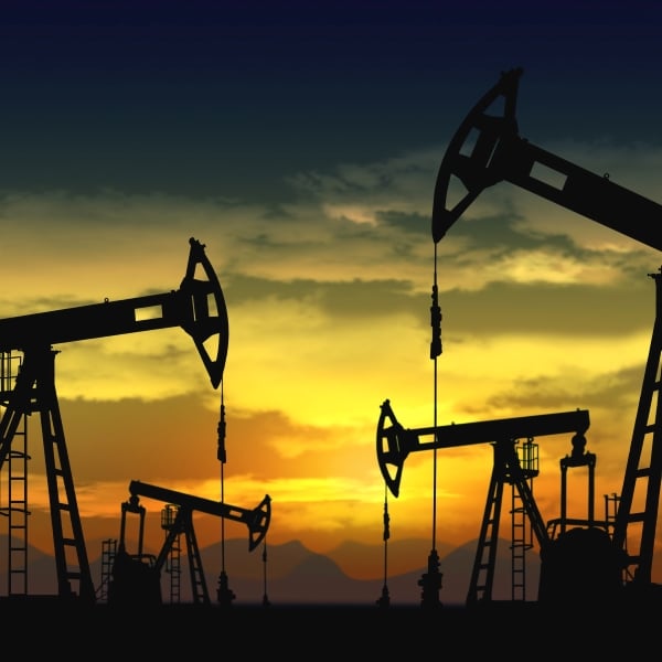 silhouettes of oil pumpjacks in the sunset 