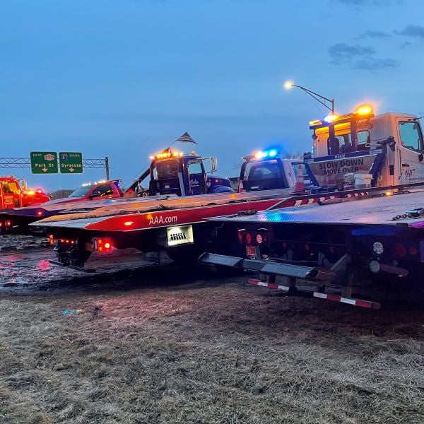 Local tow truck companies line their vehicles along the Onondaga Lake Parkway for vigil.