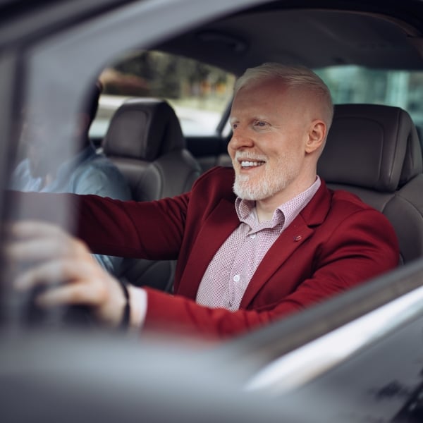 A gentleman drives his new vehicle.